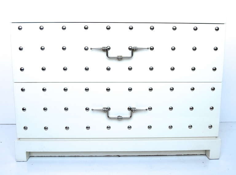 A fantastic example of Parzinger's genius.
Original white lacquer with nickel plated hardware and studs.
Branded 