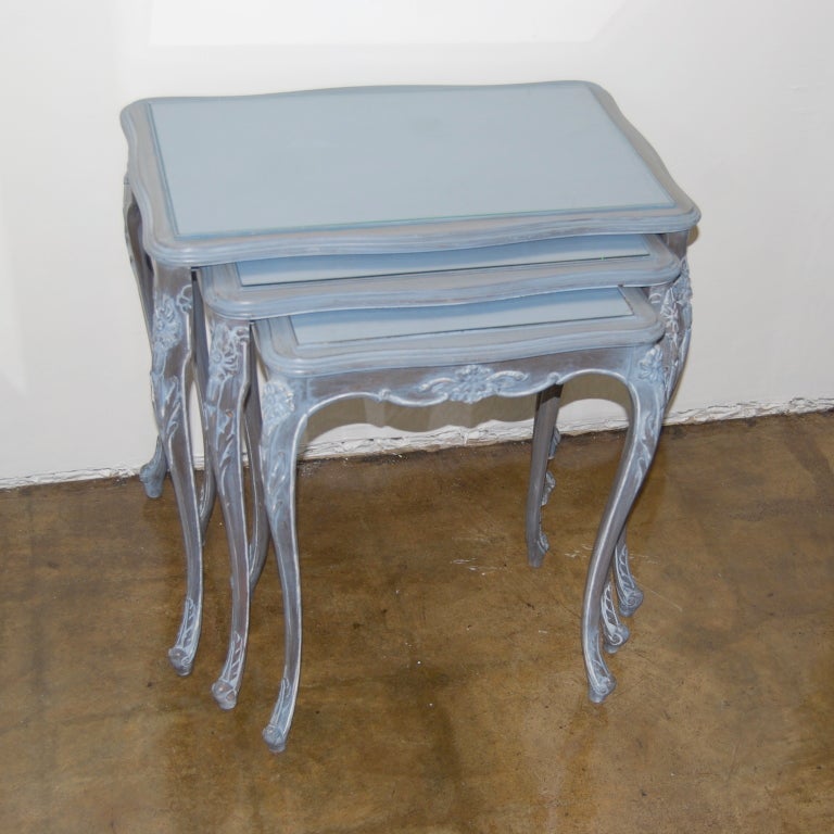 A lovely set of Jansen nesting tables in an unusual whitewashed blue painted finish.
All with inset glass tops.
Branded 