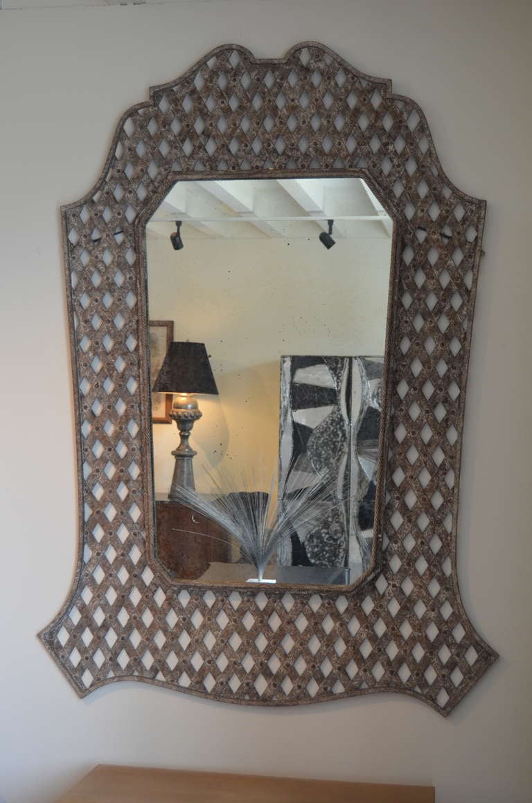 A very beautiful grandly scaled wall mirror in a distressed finish with a slightly oxidized mirror plate. Gorgeous!