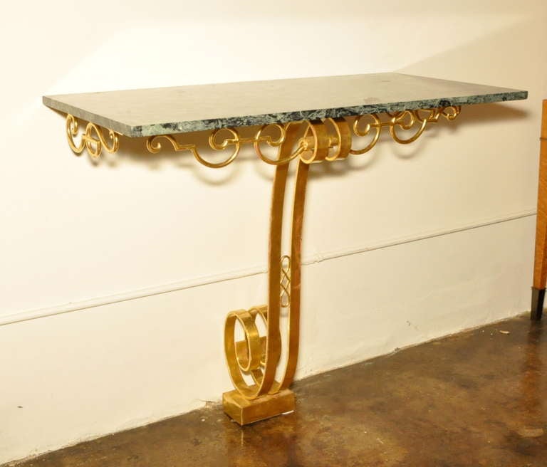 A gorgeous example in 22kt gold gilt on steel with a green marble top. 
Tres chic!
