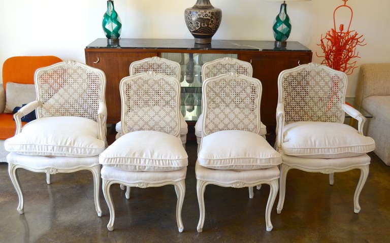 A spectacular set of Jansen dining chairs with cross hatch stenciled caned backs and silk seats. Branded 