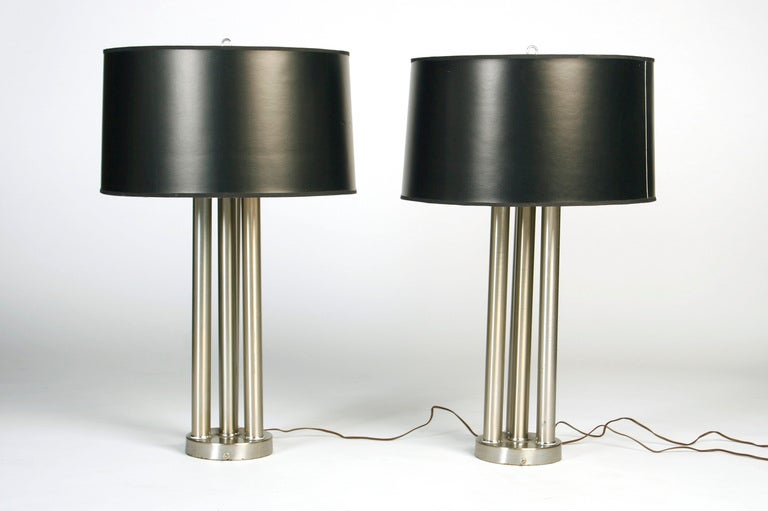 Stately architectural three column polished nickel lamps.