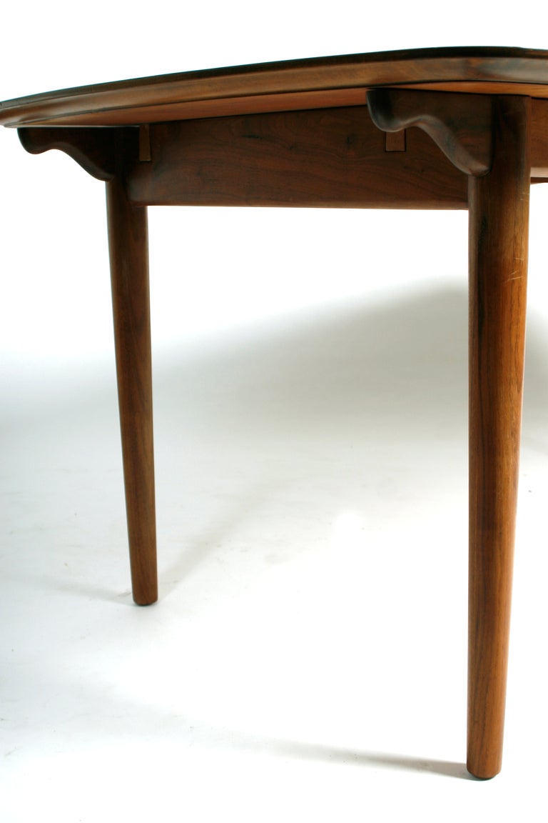 Rare Finn Juhl for Baker 1955 dining room table with two leaves and four dining room chairs.  This set features the rare maple walnut chairs with the teak table. Pure elegance by the master of danish design.