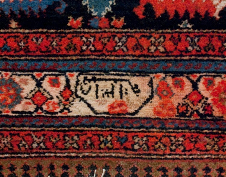 An early 20th century Persian Malayer carpet runner with wonderfully bold multicolored floral pattern surrounded by multiple floral borders.

Measures: 6' x 16'6