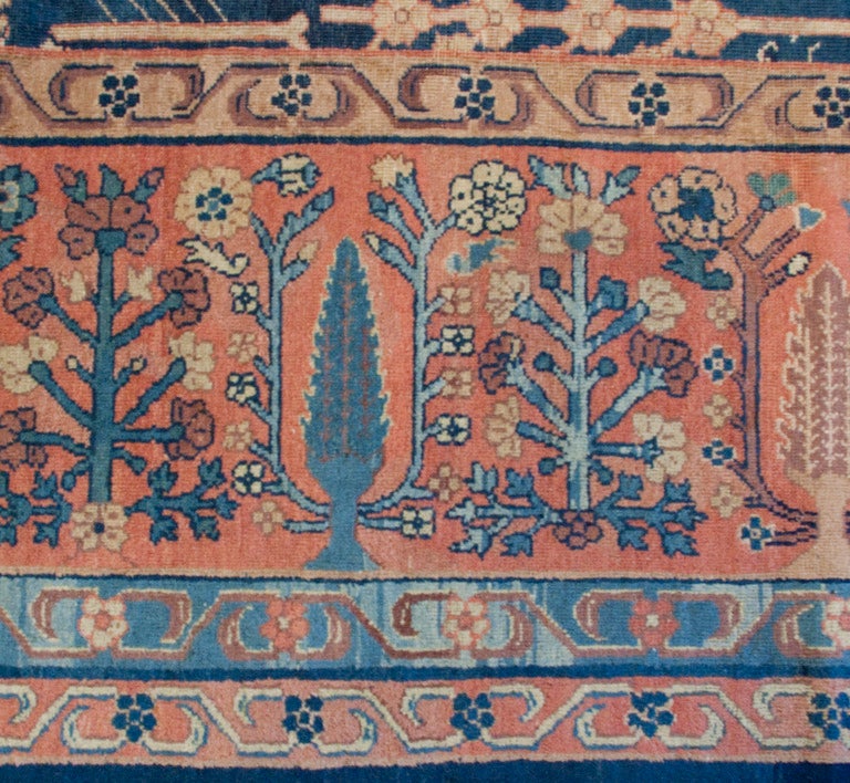 A late 19th century Indian Agra carpet with all-over tree pattern on an indigo background surrounded by a tree patterned border.

Measures: 9'8