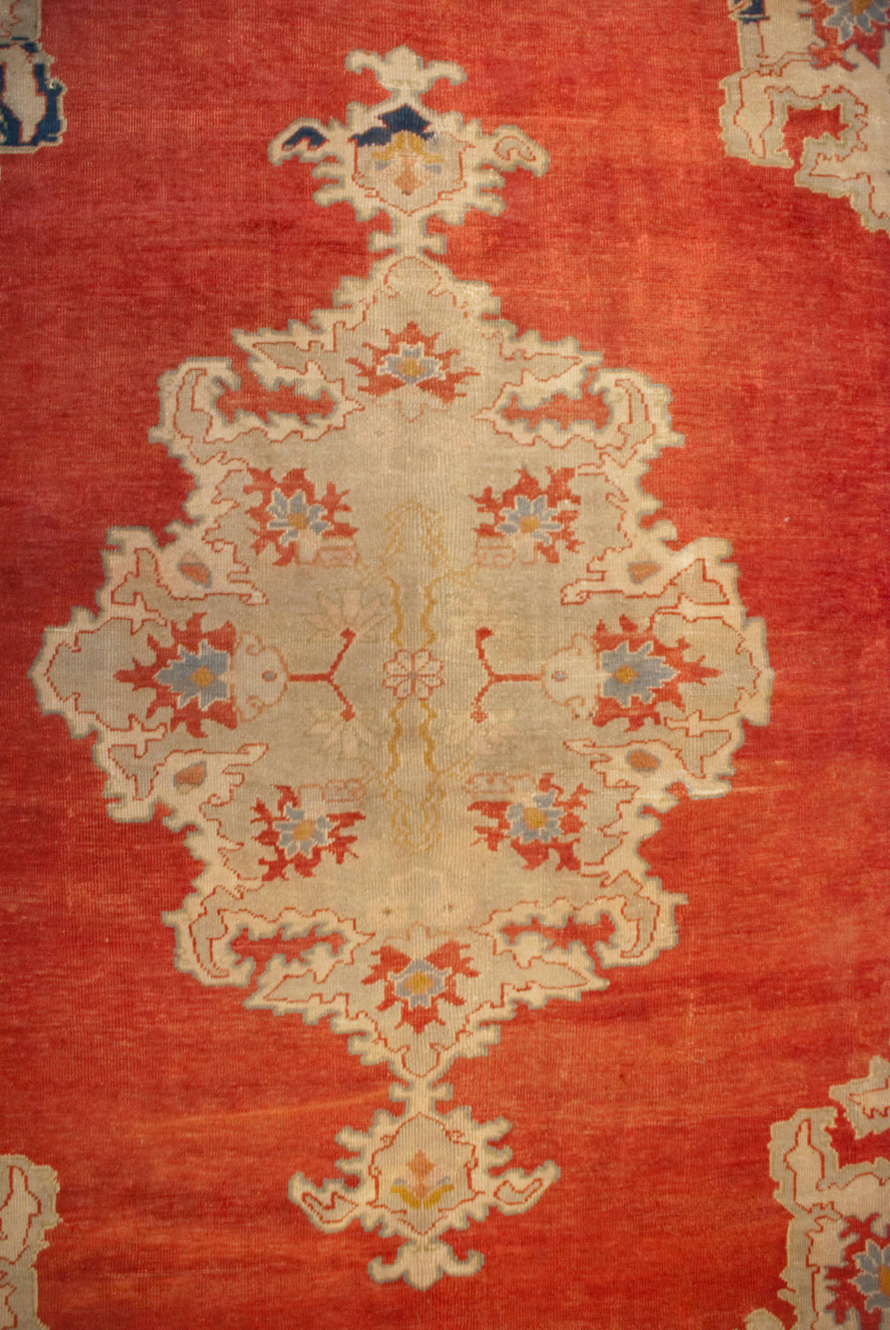 An amazing late 19th century Persian Sultanabad rug with a large central floral medallion on a rich crimson background, surrounded by a complementary floral border with an asymmetrical indigo border.