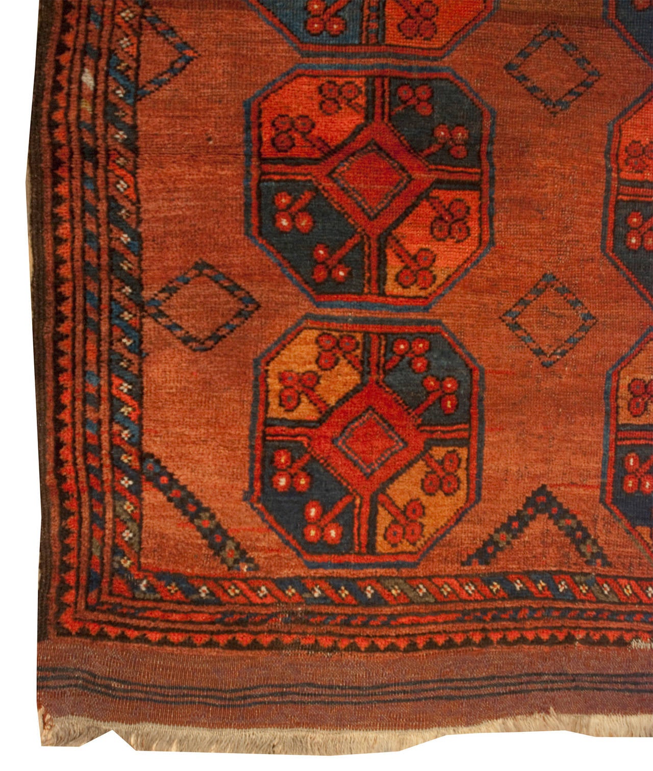 An early 20th century Afghani Keva rug with eight large octagonal floral medallions on a rusty-orange background, surrounded by multiple complementary geometric borders.
