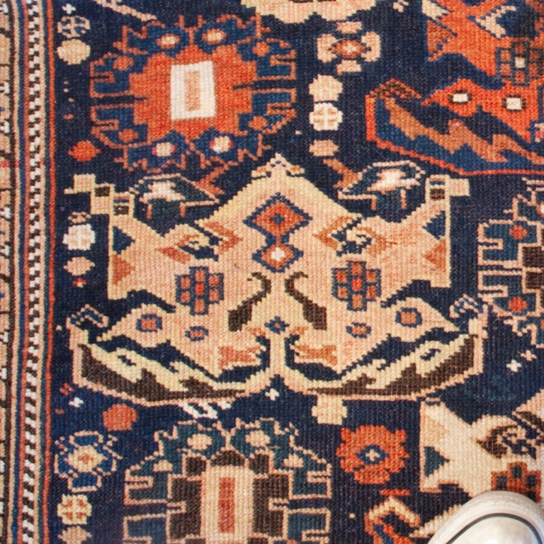 A 19th century Persian Afshar carpet with an elaborate field of floral patterns set on an indigo background, surrounded by a contrasting floral border.



Measures: 4' x 5'3