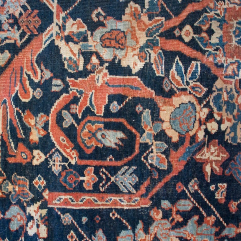 A 19th century Persian Sultanabad carpet with all-over floral and vine pattern on an indigo background, surrounded by a contrasting floral border.



Measures: 9'5
