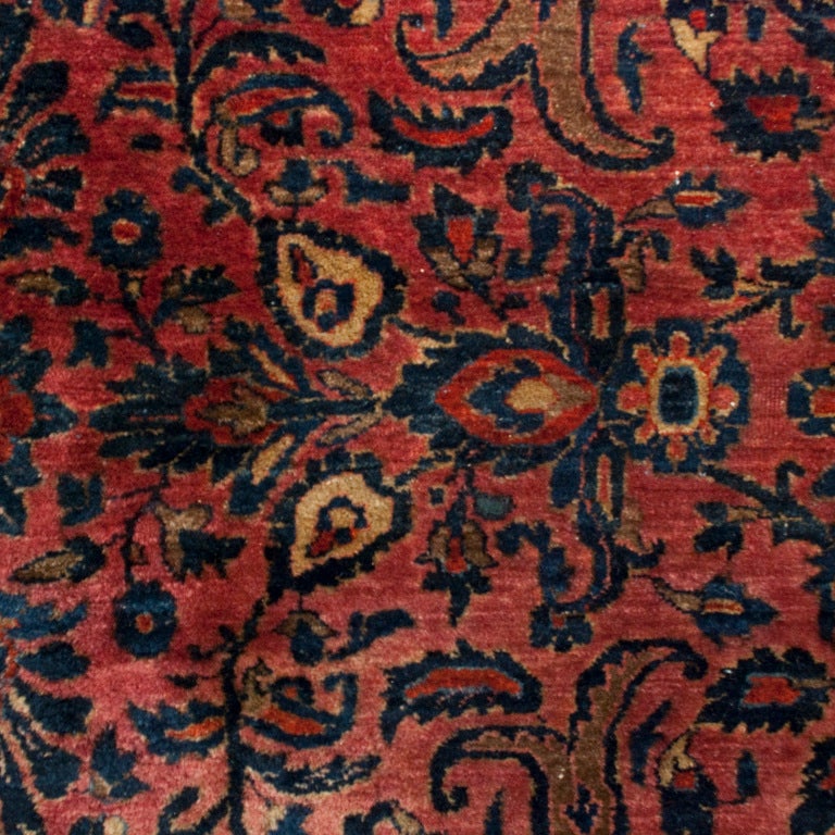 An early 20th century Persian Saruk carpet with all-over floral and vine pattern on a cranberry background with a complementary floral border.

Measures: 12' x 15'.


