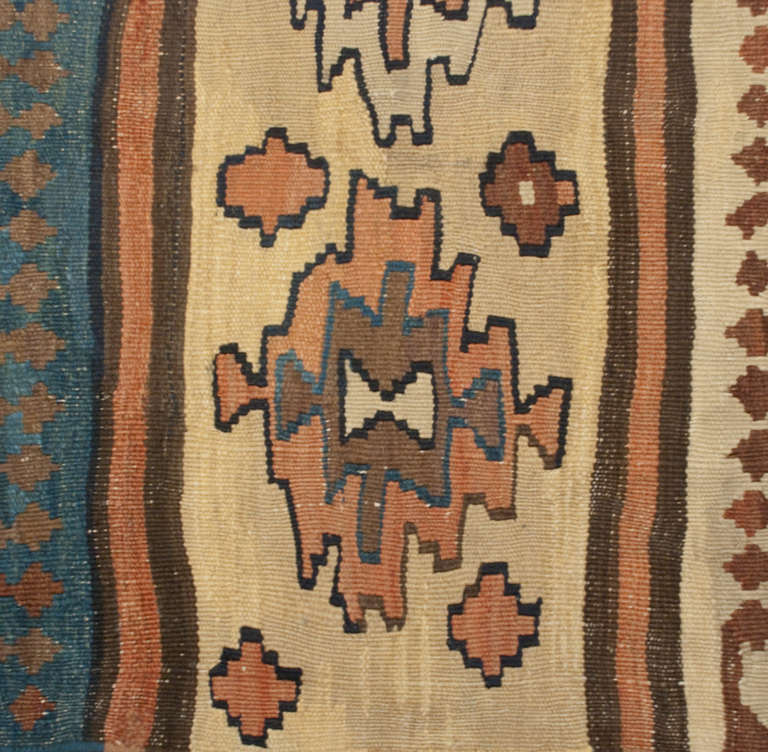 An early 20th century Persian Azeri Kilim runner with alternating geometric patterns and multi-color stripes.