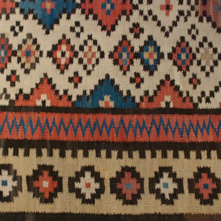A 19th century Persian Saveh Kilim carpet runner with all overall geometric field surrounded by alternation geometric borders.

Measures: 3'8