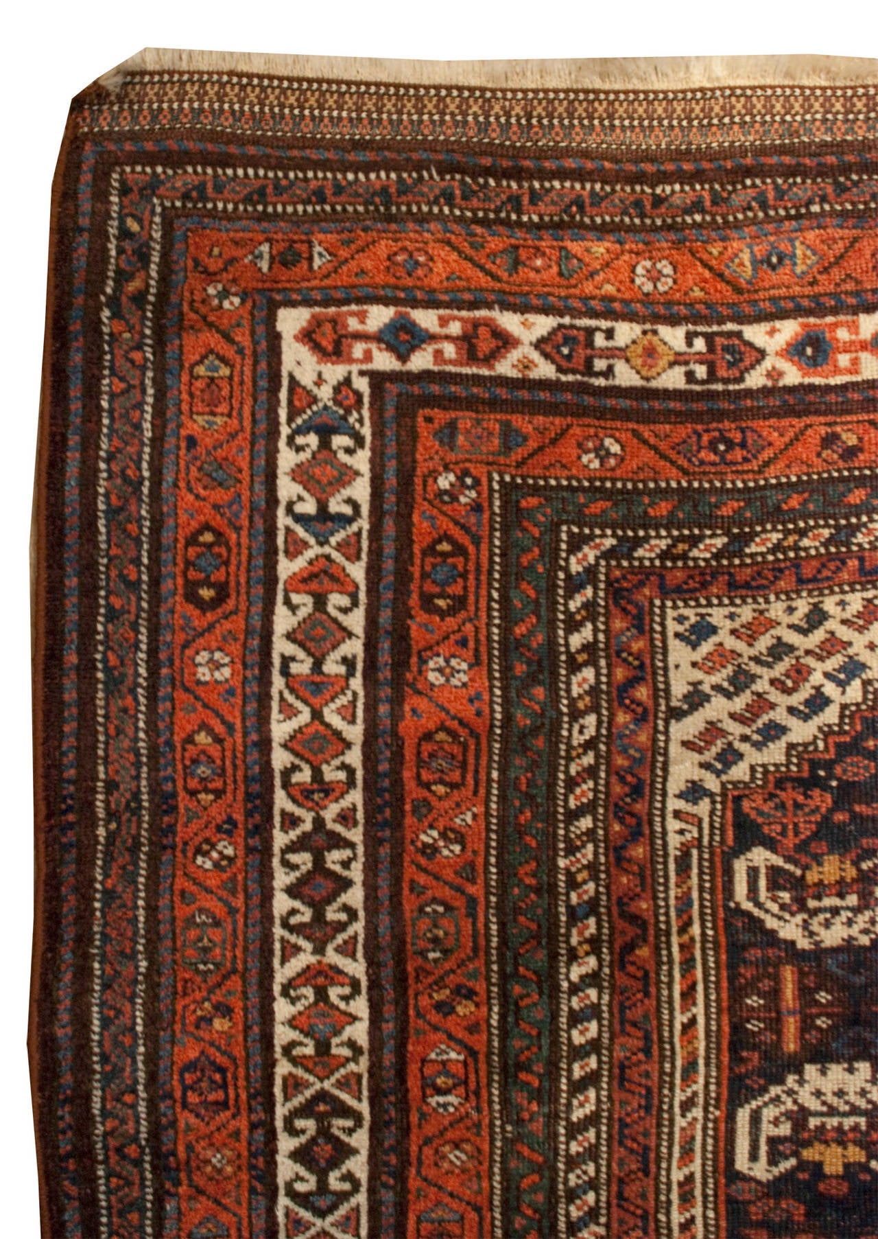 A 19th century Persian Lori rug with a small geometric field surrounded by multiple intricately woven geometric borders.