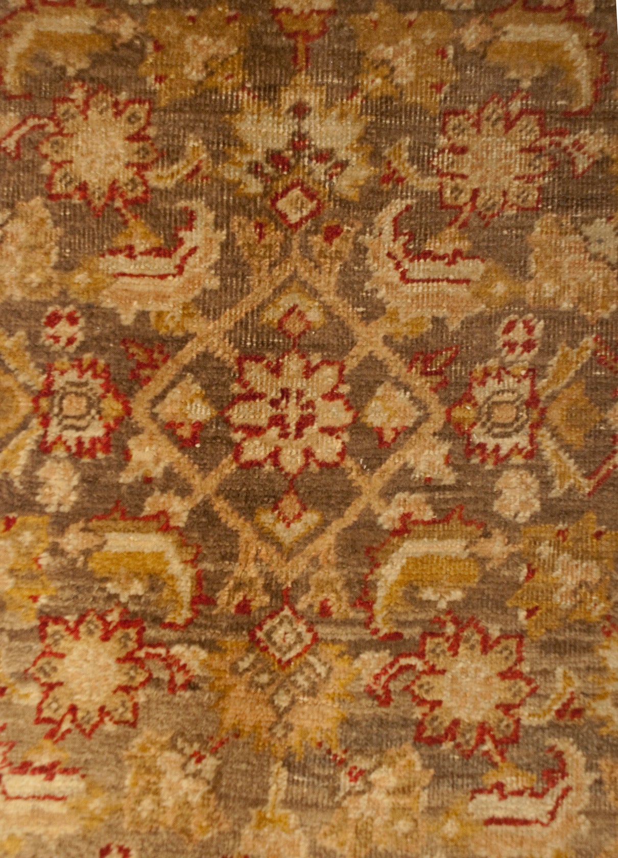 An early 20th century Persian Tabriz rug with a wonderful crimson, gold, and cream floral lattice pattern on a natural, undyed wool, background surrounded by a beautiful crimson and floral border.