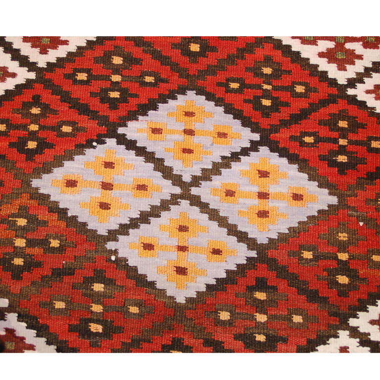 An early 20th century, circa 1940, Persian Saveh runner with brilliant diamond pattern of alternating multicolored geometric patterns, surrounded by a contrasting geometric border.