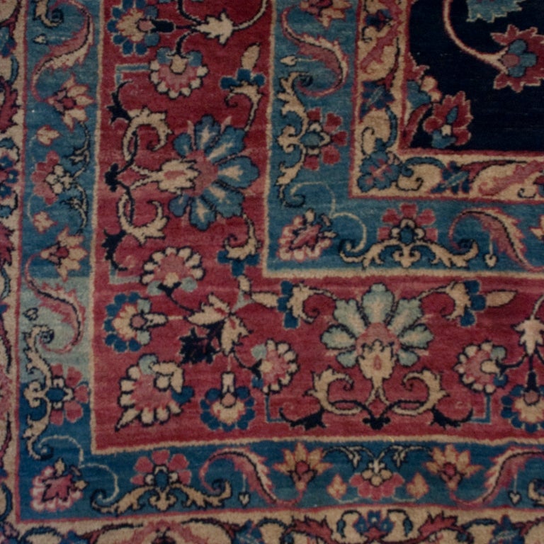 A 19th century Persian Yadz carpet with tree of life pattern on an indigo background, surrounded by a contrasting floral border.

Measures: 8'7