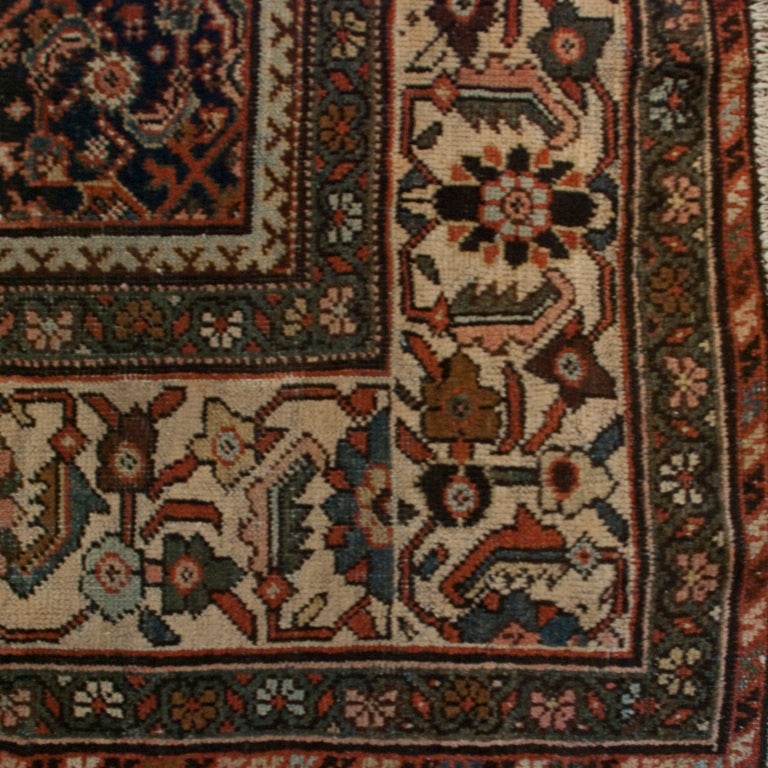 An early 20th century Persian Herati carpet with one central diamond medallion with tree of life motif on a crimson background surrounded by a contrasting floral border.

Measures: 8'3