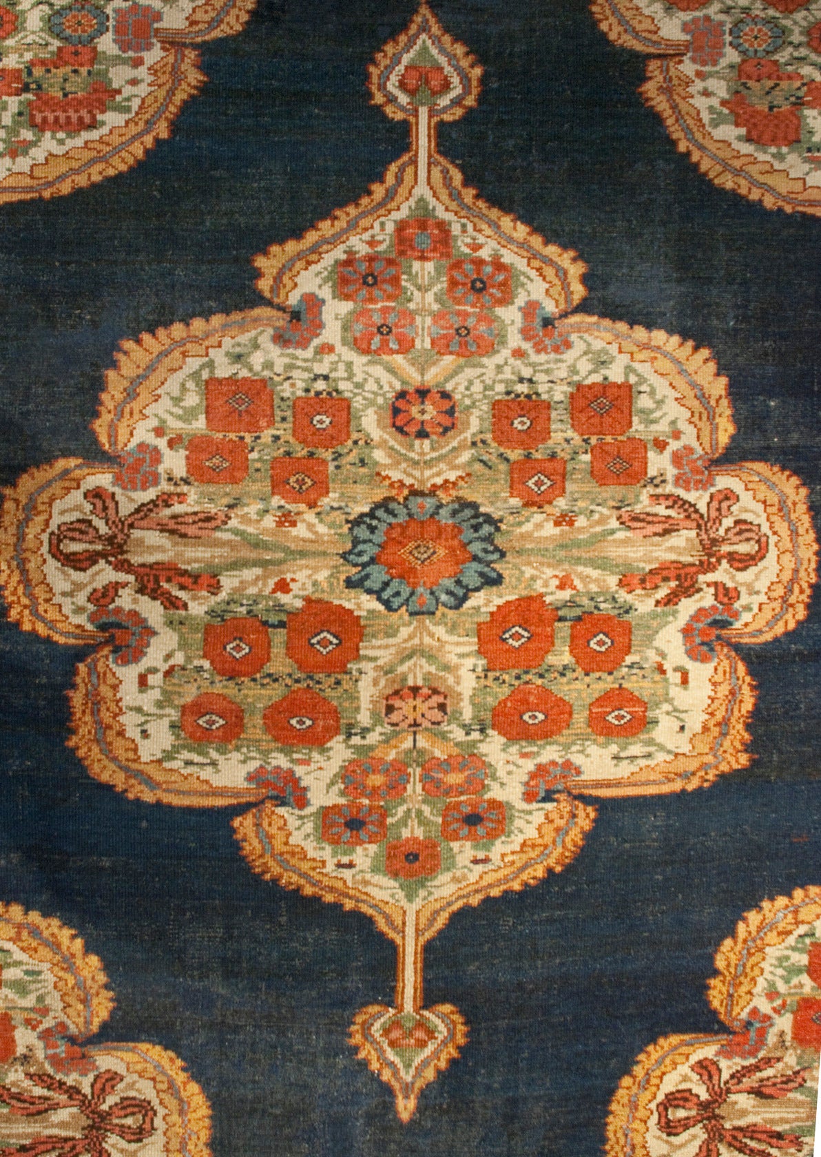 A beautifully woven, exceptional quality, early 20th century Bakhtiari Mission Malayer runner with three large-scale floral medallions on an indigo background, surrounded by an even more beautiful floral border.