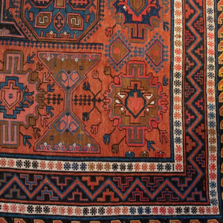 An early 20th century Russian Kilim carpet with three central medallions surrounded by multiple geometric designs and a contrasting border.

Measures: 7'4