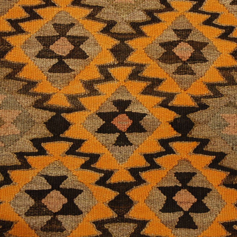 An early 20th century Persian Qazvin kilim runner with all-over multi-colored zigzag geometric pattern surrounded by multiple complementary geometric borders.