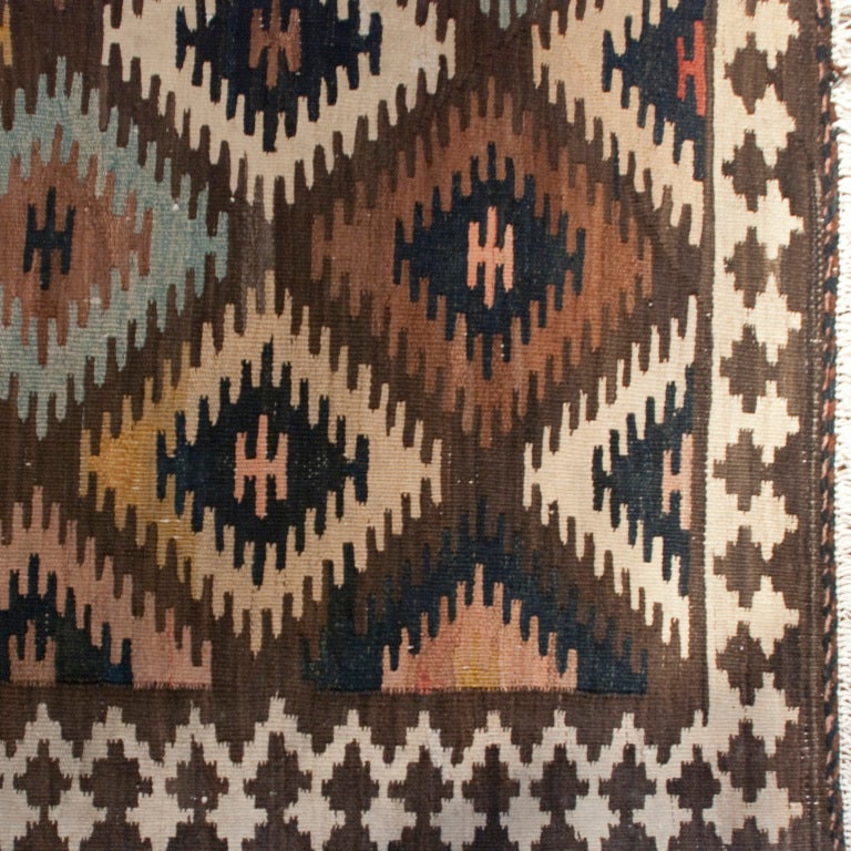 An early 20th century Persian Shahsavan carpet with all-over geometric multicolored diamond pattern surrounded by a contrasting diamond patterned border.

Measures: 4'3