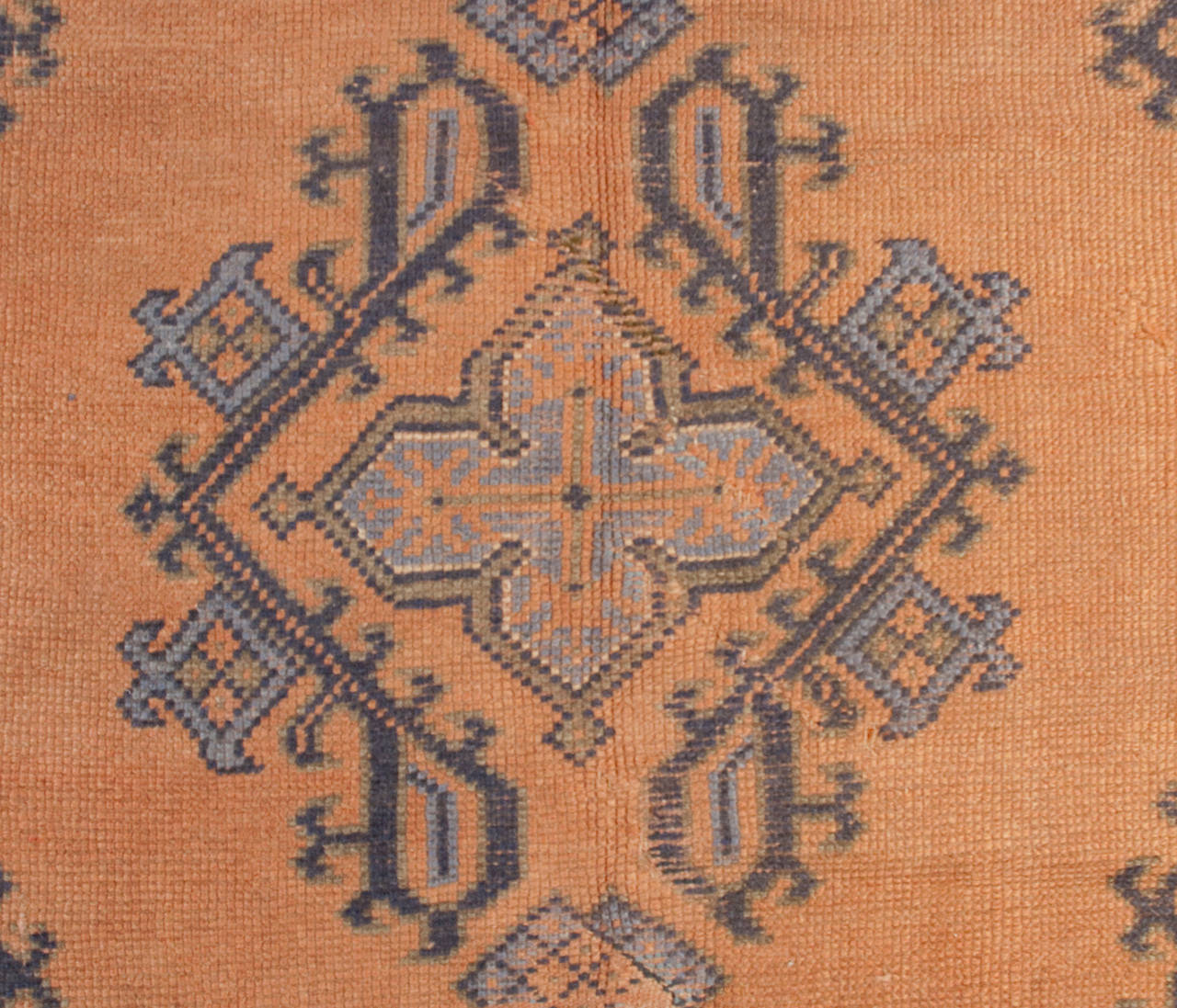 A late 19th century Turkish Oushak rug with multiple geometric and floral medallions on a burnt orange background surrounded by multiple floral borders.