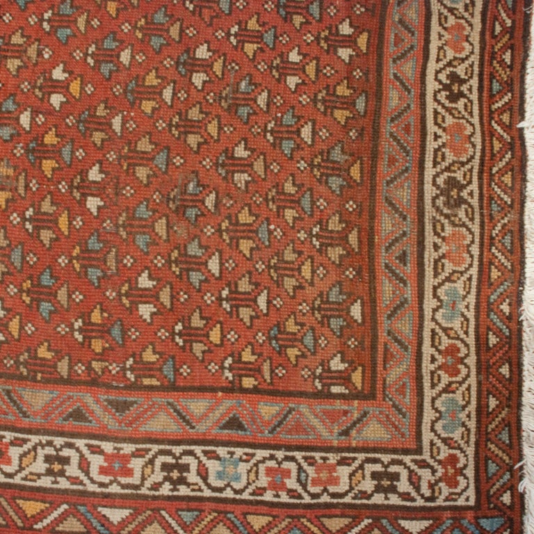 A 19th century Persian carpet with all-over floral pattern on a burnt orange background surrounded by a contrasting floral border.

Measures: 3'6