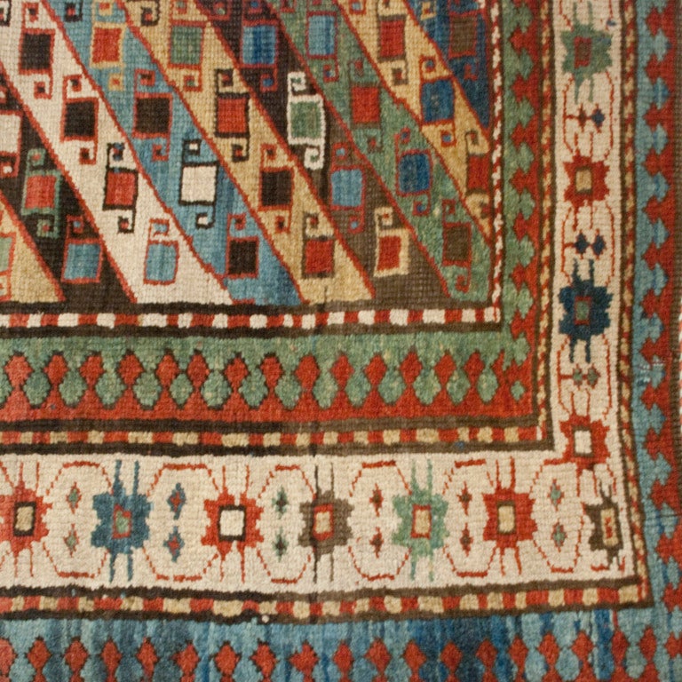 A late 19th century Persian Talish carpet with wonderful multicolored stripes with geometric patterns surrounded by everal contrasting floral and geometric pattern borders.

Measures: 3.9
