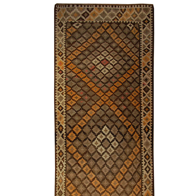 An early 20th century Persian Arsin Kilim runner with criss-crossing diamond pattern surrounded by a contrasting diamond border.