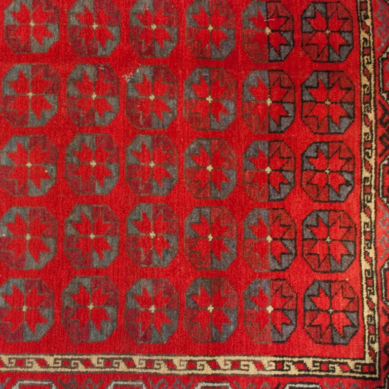 An early 20th century Uzbek Turkmen carpet with geometric floral pattern surrounded by a complementary border.

Measures: 5'4