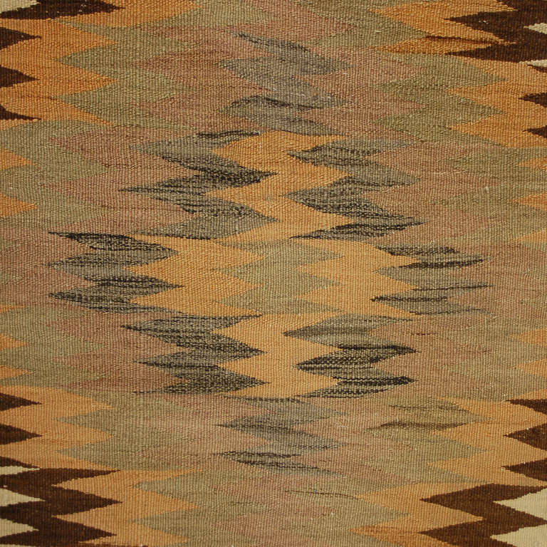 An early 20th century Persian Kelardasht Kilim runner with zigzag woven pattern surrounded by a complementary border.