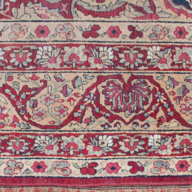 An early 20th century Persian Lavar Kerman carpet with wonderful central floral medallion amidst a field of floral patterns, surrounded by a contrasting border.

Measures: 9.8