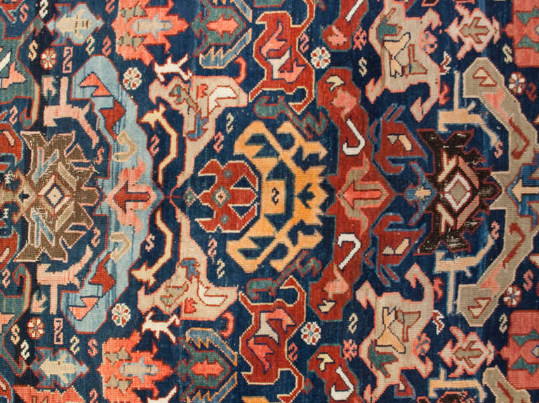 An amazing antique 19th century Persian Kareback rug with an elaborate all-over multicolored floral pattern surrounded by a complementary floral border.
