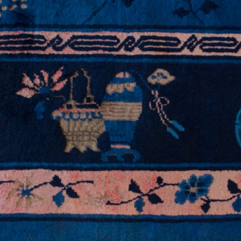 An early 20th century Chinese Feti carpet with indigo background surrounded by a floral and vase patterned border.

 


 