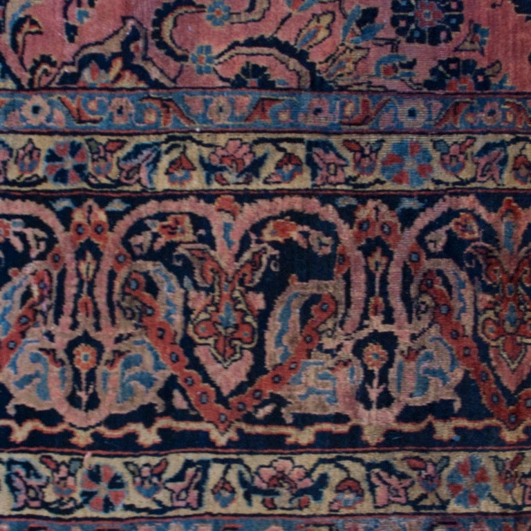 A late 19th century Persian Sarouk carpet with all over tree-of-life pattern surrounded by a complementary floral border.

Measures: 9'8