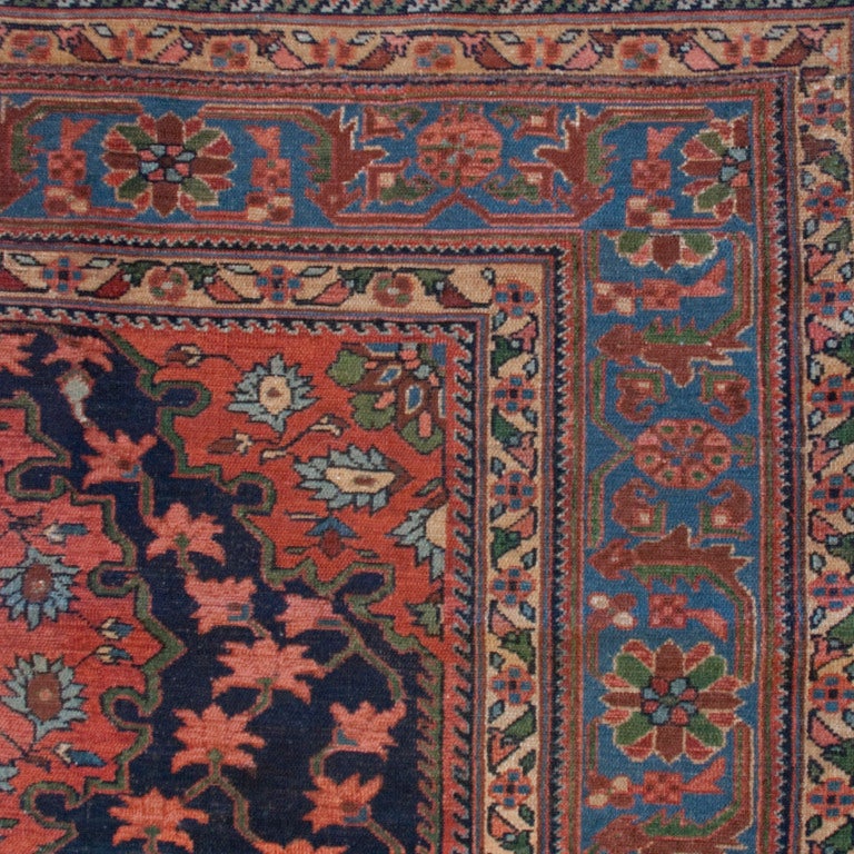 A 19th century Persian Nahavand carpet with three red central floral medallions on surrounded by green scrolling vines with red flowers on an indigo background with contrasting floral borders.  



Measures: 5' x 6'5".





Keywords: