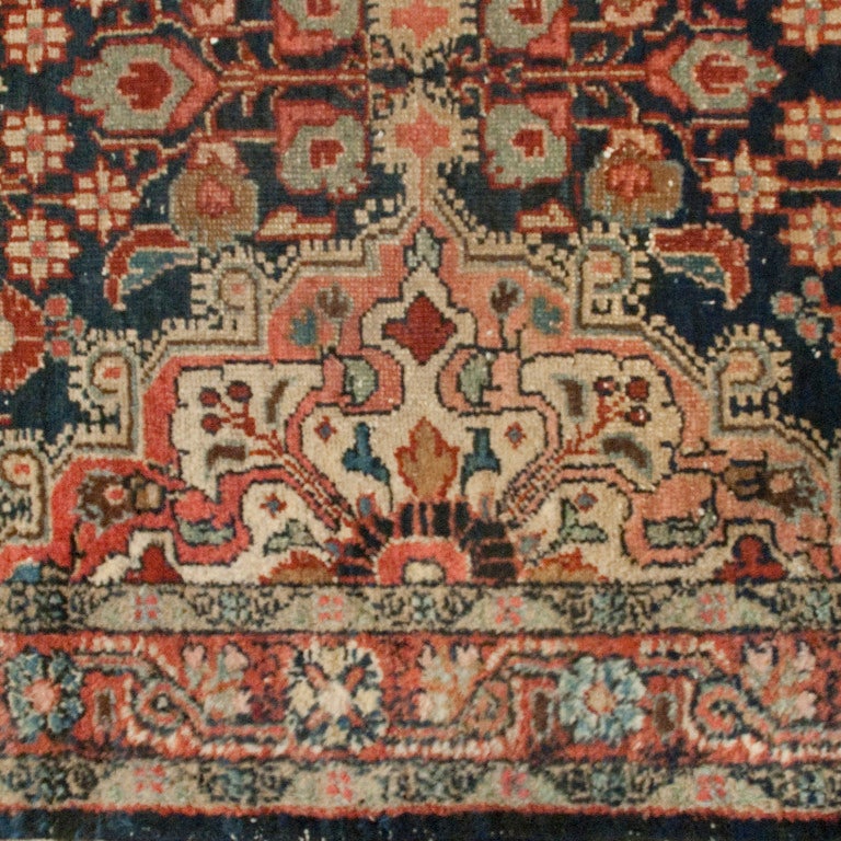 An early 20th century Persian Malayer carpet runner with four central diamond medallions amidst an intense field of flowers.

Measures: 2'5