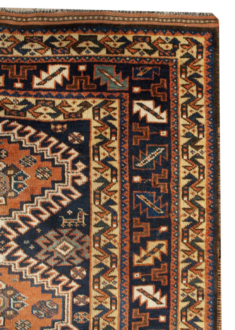 An amazing, circa 1900, early 20th century Persian Yalameh runner with nine geometric woven diamond medallions amidst a field of woven geometric flowers and goats on an indigo background, surrounded by multiple contrasting floral borders. Truly a