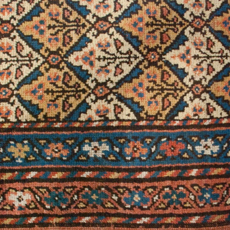 An early 20th century Persian Malayer carpet runner with all-over pattern of miniature trees surrounded by multiple contrasting borders.

Measures: 3'6