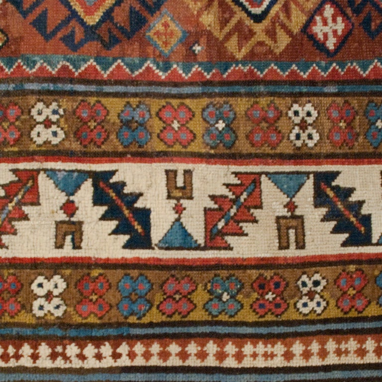 A 19th century Persian Shirvan carpet runner with multiple geometric medallions surrounded by multiple contrasting geometric borders.

Measures: 3'3