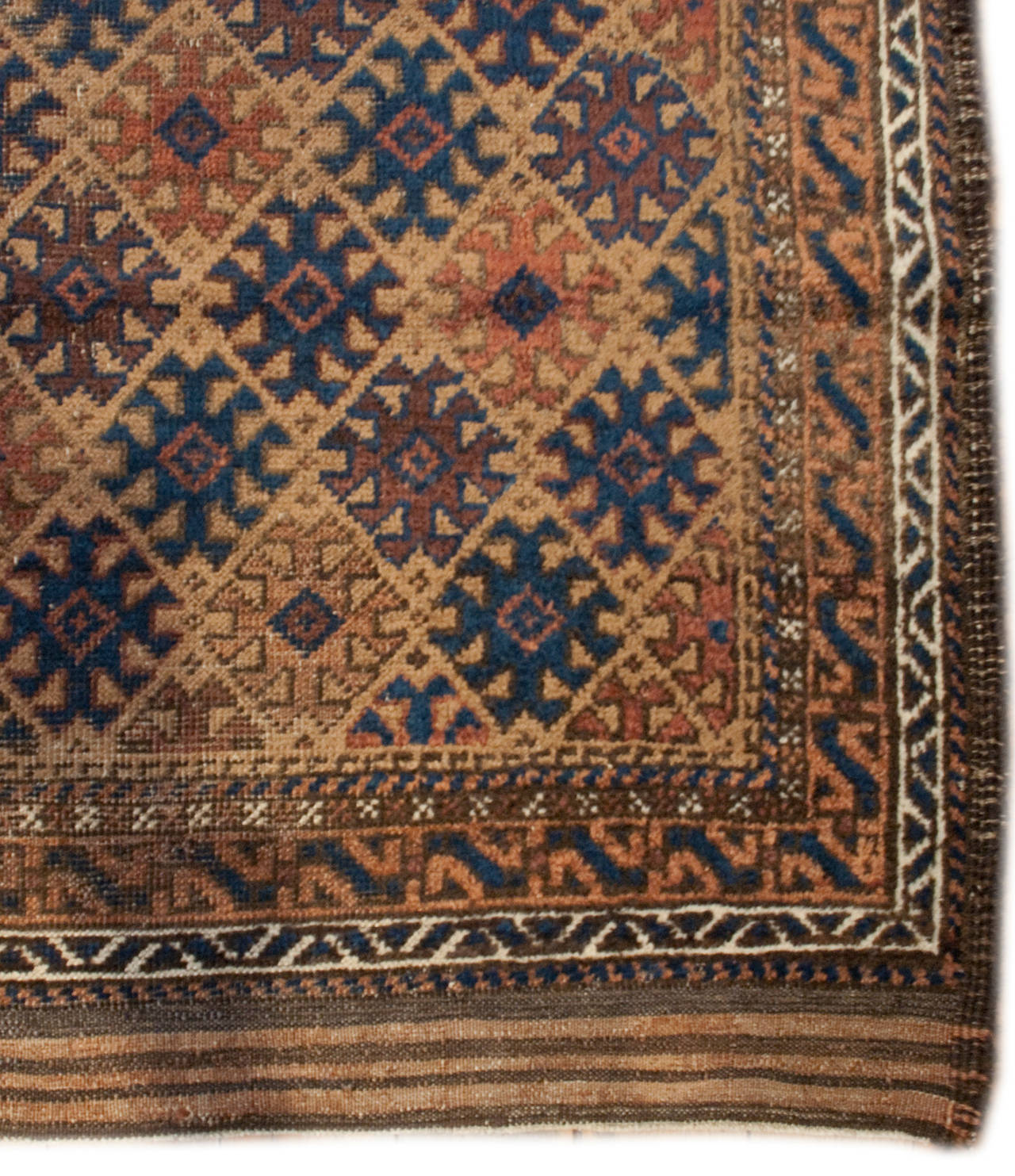 A wonderful early 20th century Persian Baluch rug with a wonderful all-over multicolored geometric pattern surrounded by multiple complementary borders.