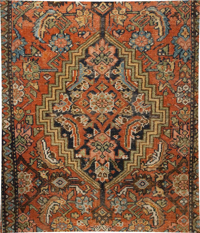 A 19th century Persian Serab rug with intensely intricate floral field surrounded by a geometric border, with an interesting additional wide border feating a repeated paisley pattern.
