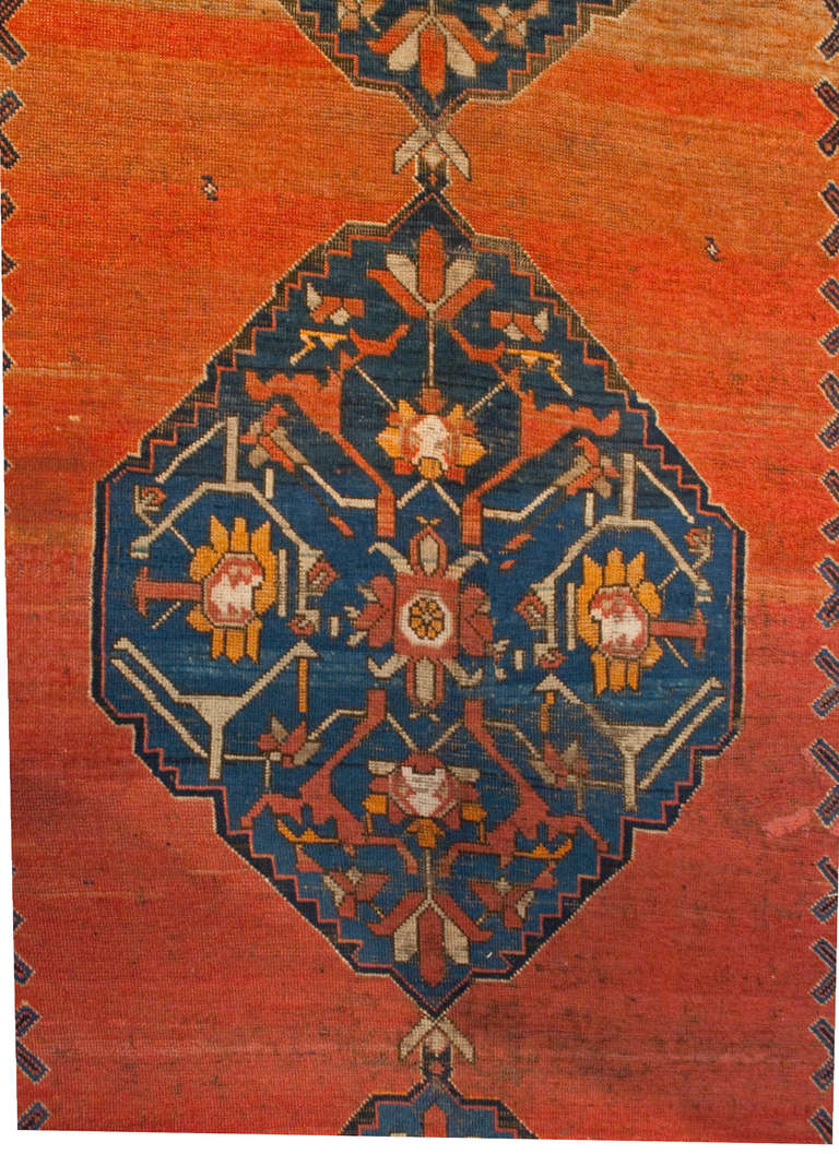 An amazingly beautiful mid-19th century Kareback rug with a gorgeous orange to crimson ombre background with three geometric and floral medallions surrounded by an intricate floral border.