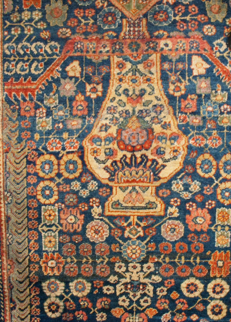 A late 19th century Persian Sultanabad runner with an amazing tree-of-life woven pattern surrounded by a crimson and indigo floral motif border.