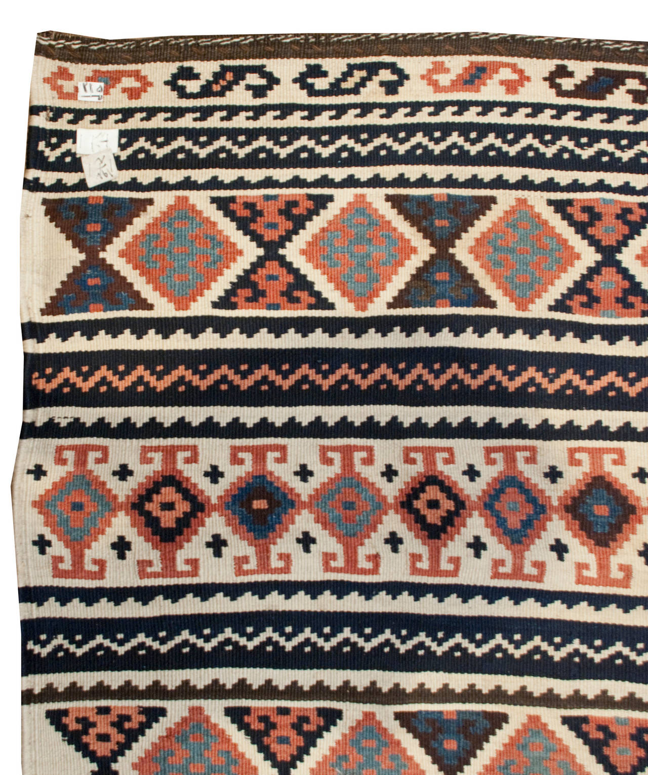 An early 20th century Persian Lori Kilim runner with a wonderful asymmetrical pattern consisting of bold multicolored geometric patterns on one end, and graphic alternating stripes on the other.