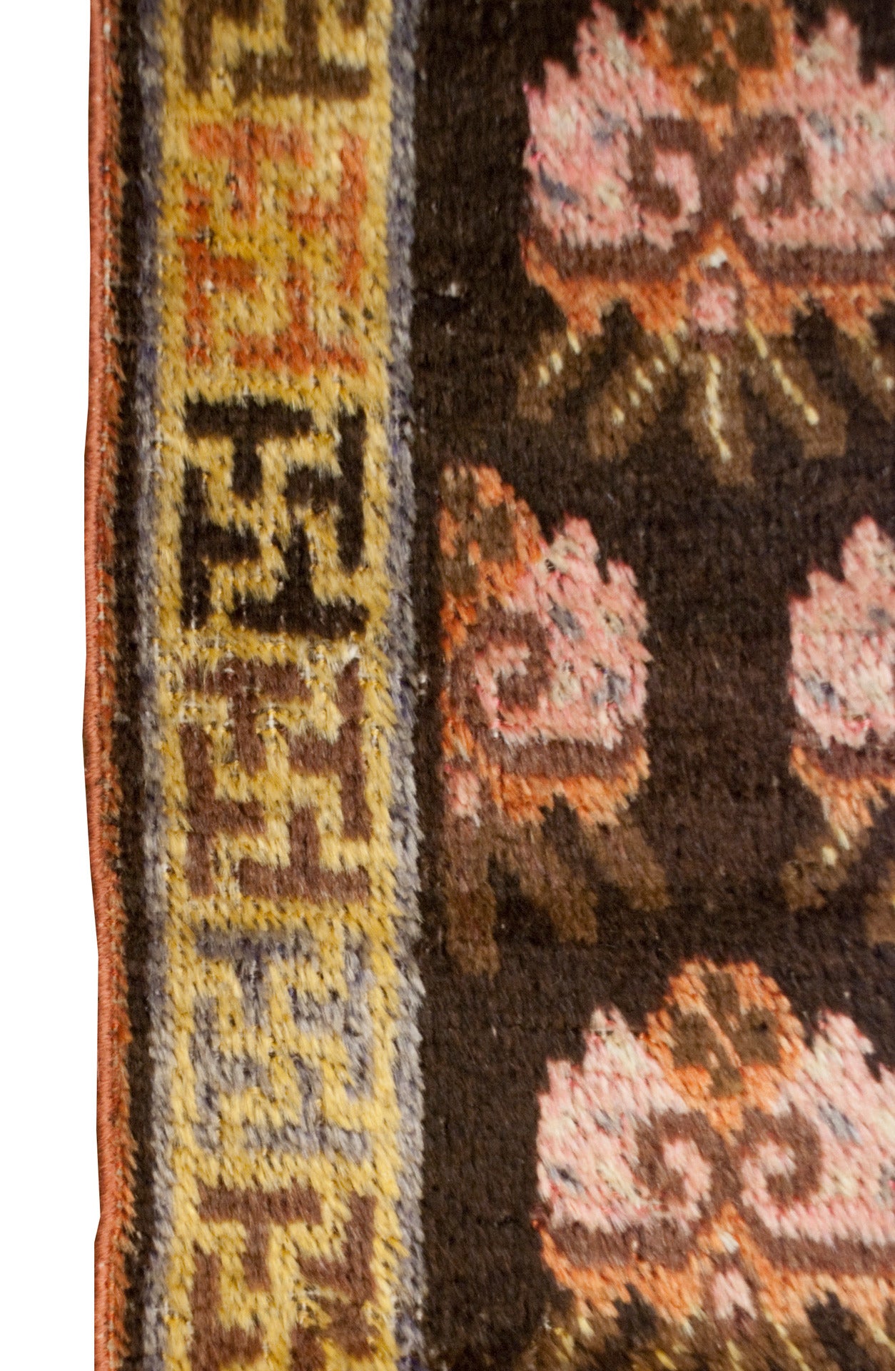 An early 20th century Central Asian Khotan prayer rug with an all-over floral motif, surrounded by a wonderful 
