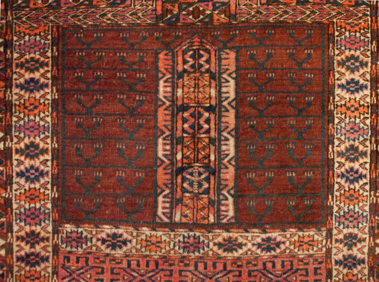 An early 20th century Persian prayer rug with wonderful geometric and floral patterns surrounded by multiple complementary borders.