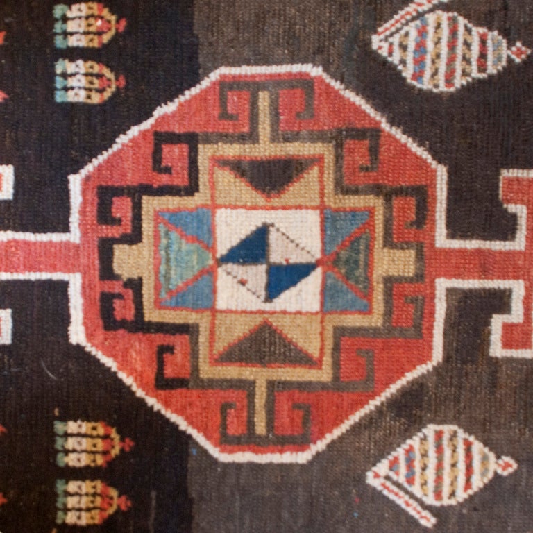A 19th century Persian Azari carpet runner with five central medallions surrounded by large scale paisley motifs with a multi layered border.

Measures: 10'6