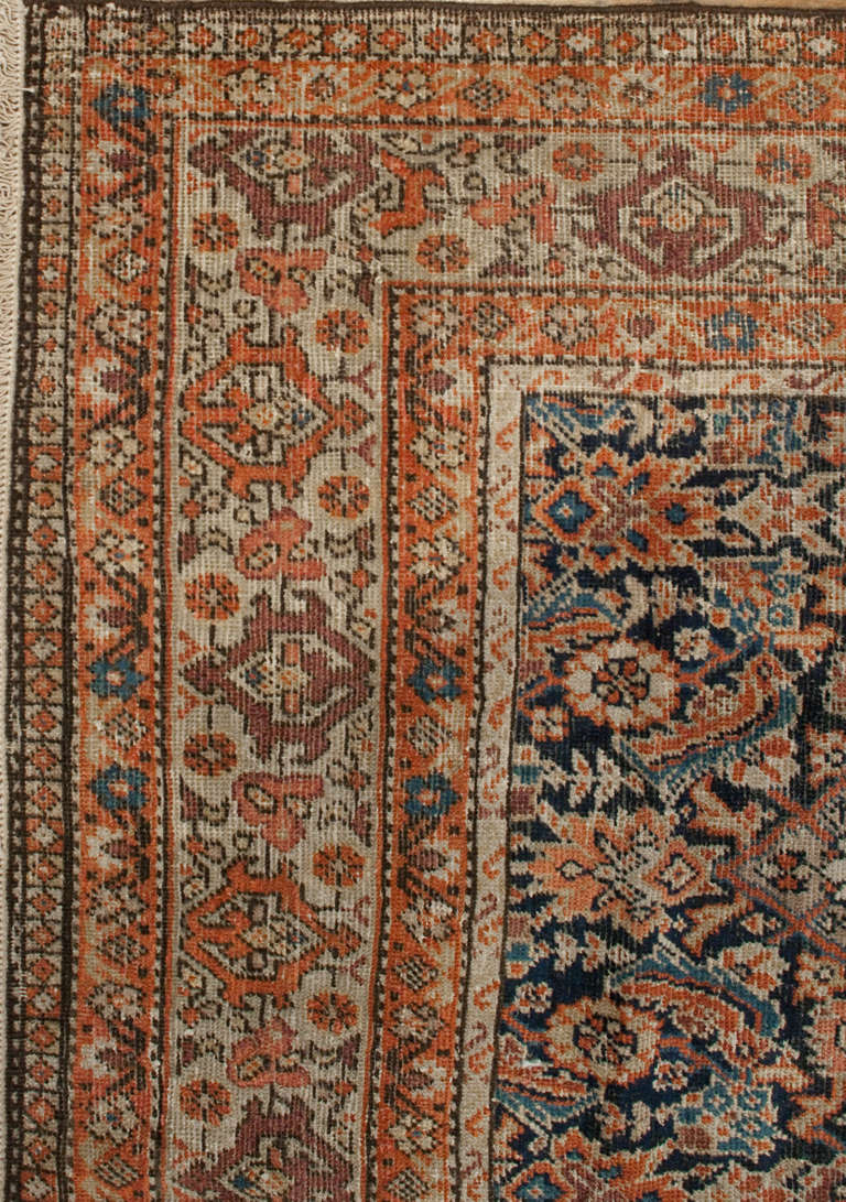 A late 19th century Persian Ferehan Herati rug with a beautiful all-over floral pattern surrounded by multiple complementary floral borders.
