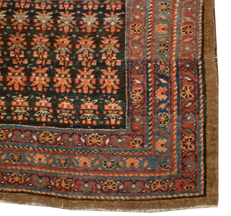 A late 19th century Persian Bidjar runner with all-over floral pattern on a wonderful variegated indigo and natural wool background surrounded by multiple contrasting floral borders.